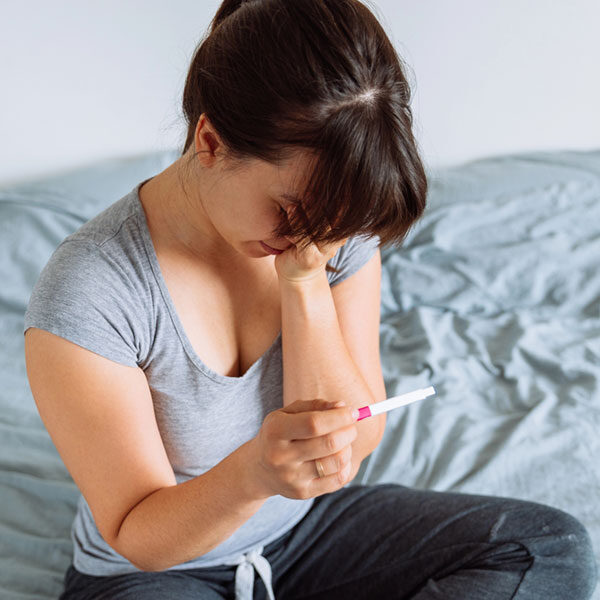 Woman looking at results of a pregnancy test