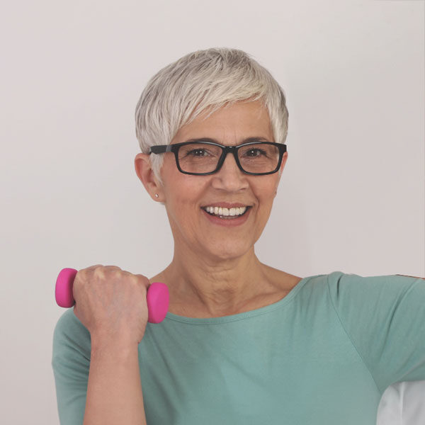 older woman exercising arm with light dumb bell